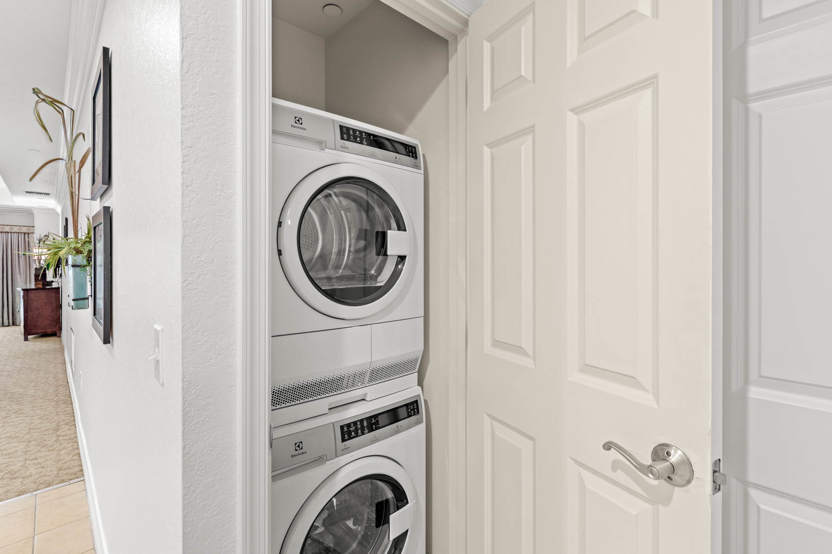 stacked laundry unit in white closet